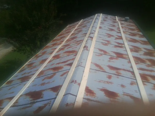 Rusted metal roof panels with new wood purlins before replacement — Storm Damage Roof Repair in Ballwin by Roofing Brothers
