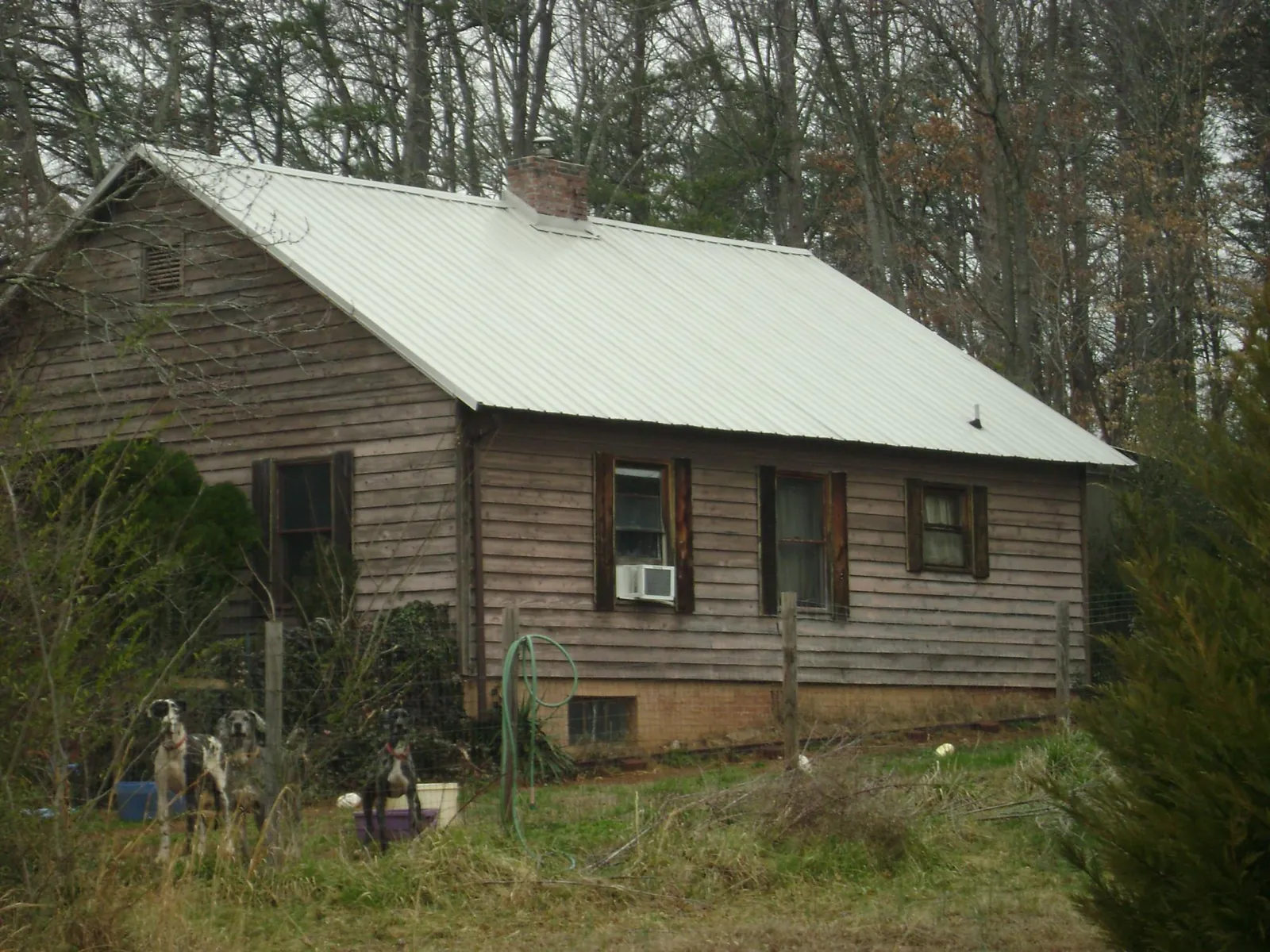 White metal roof on an old wood sided farmhouse, from a Metal Roof Installation job in Ballwin